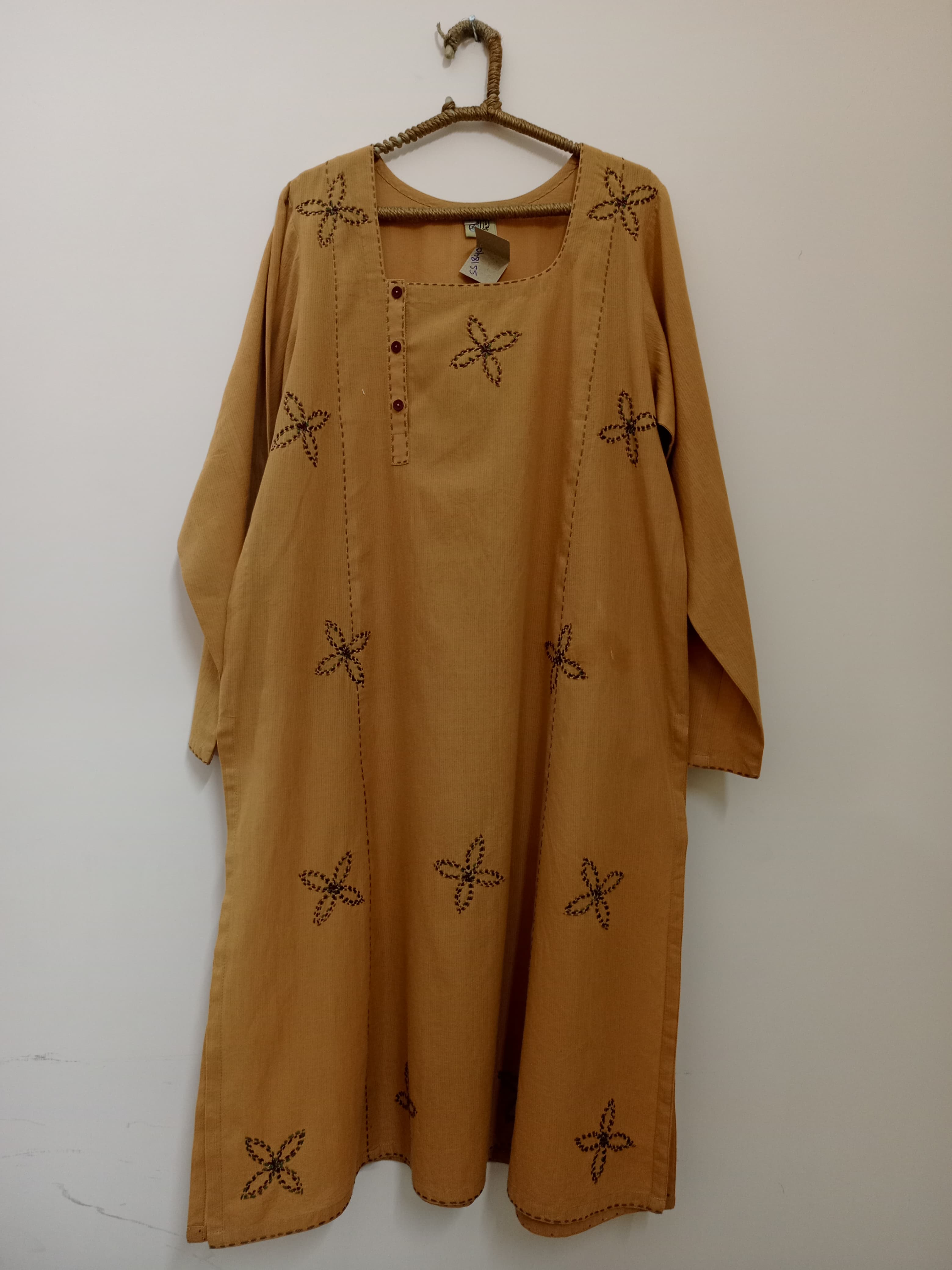 Rich brown shirt with fine embroidery accents, textured fabric feel, and clean lines that bring depth and quiet sophistication together beautifully.